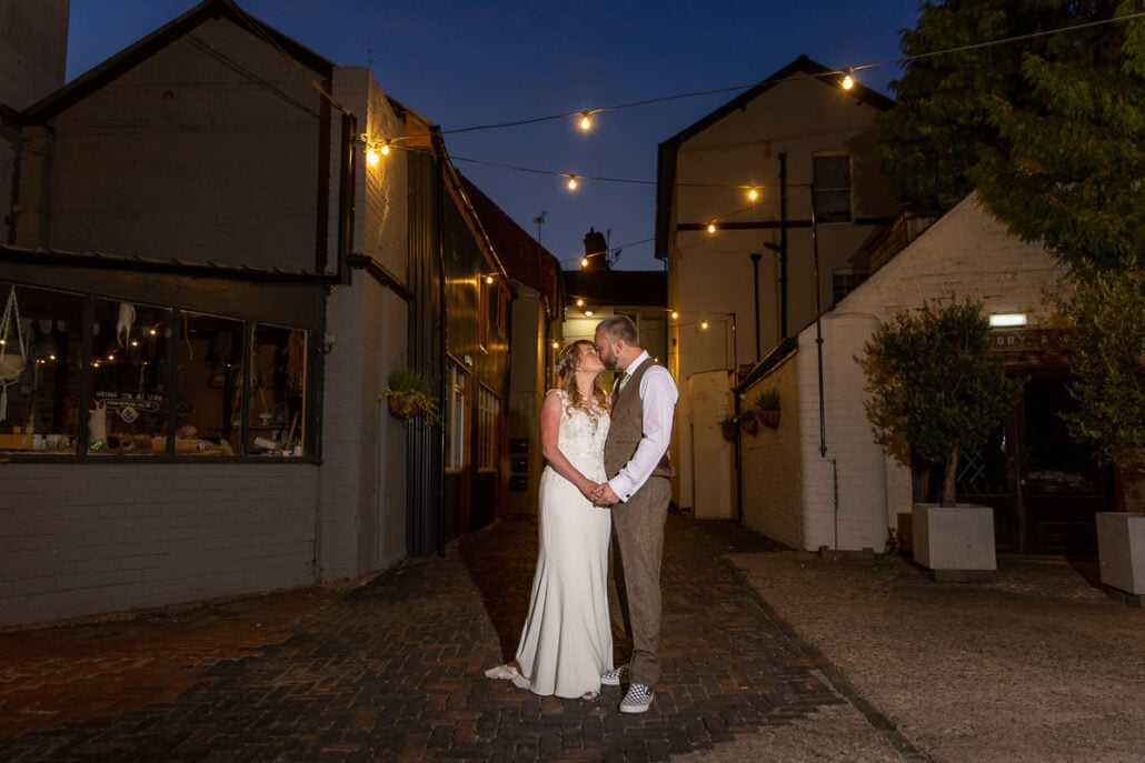 A south Wales wedding photographer captures a bride and groom in a narrow alleyway at night.