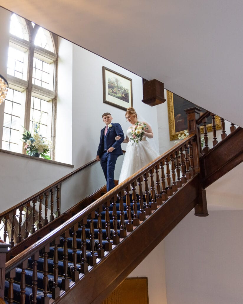 A bride and groom captured by a South Wales wedding photographer on the stairs of a building.